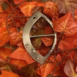paw print scarf ring on autumn leaves